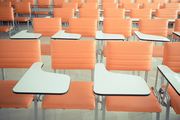 Vintage tone of Orange school chairs in empty classrooms