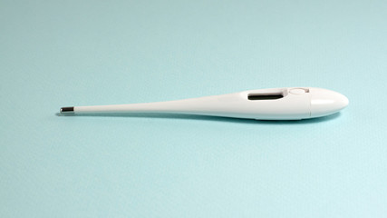 White thermometer on a blue background