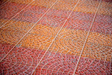 Naklejka na ściany i meble Cobblestone pavement with circular pattern
