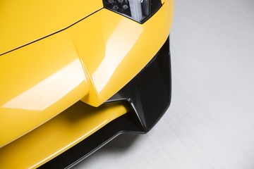 Closeup shot of the exterior details of a modern yellow sport car