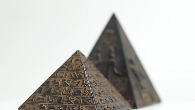 pyramid figurine. figurine pyramid on a white background. the pyramid is spinning

