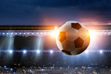 Full night football arena in lights with ball close up