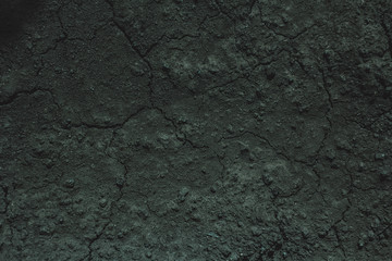 Dark soil texture closeup of dry soil background