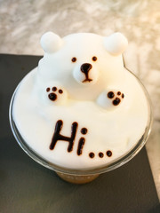 Iced cappuccino coffee has a fizzy bear and letters hi