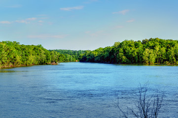 A view looking down stream on the Catawba river with forest on each side.