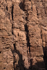 Entrance to the Wadi Mujib canyon in Jordan. Steep rocks and a rapid flowing river carved. Difficult crossing and attraction for tourists on the water route.
