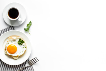 Fried eggs, coffee for breakfast on white table top view copy space