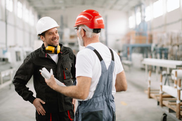 Colleagues working together. Workers in factory.	