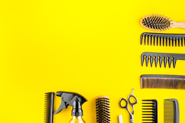 Hairdresser tools. Flat lay on yellow background top view copy space