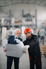 Colleagues working together. Arhitect and worker in factory.	