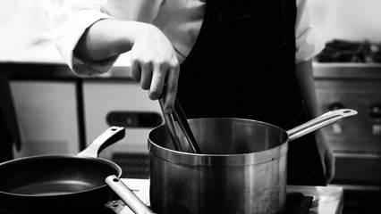 Chef cooking in a kitchen, chef at work, Black & White.
