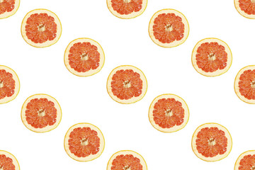 Seamless pattern of isolated slices of grapefruit. Wallpaper for background, design and packaging.