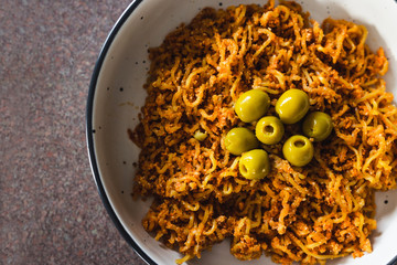 plant-based food, vegan sticky ginger noodles with green olives and breadcrumbs