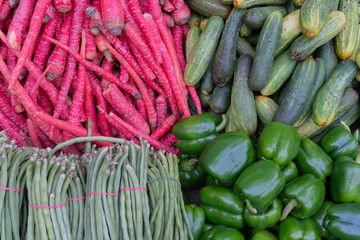 Beans, carrots, cucumber and capsicum, vegetables for sale in a market in Territy Bazar, Kolkata, West Bengal, India.