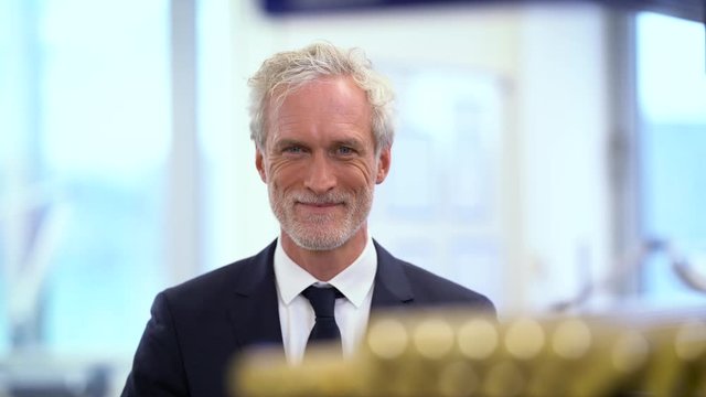 Smiling manager looking at camera in factory