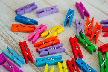 Clothespins wooden multi-colored, decorative. Background for hobbies and needlework.