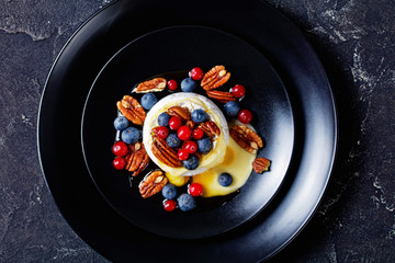 Round shape whole baked brie with nuts and berries