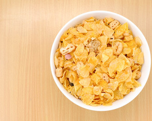 cereal in a white bowl on wooden background. Healthy breakfast concept.