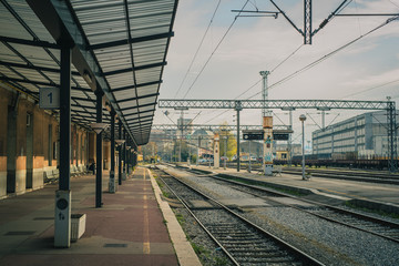 Deserted train station in Rijeka, croatia, in late autumn morning. No trains and people on the platforms on an old style train station.