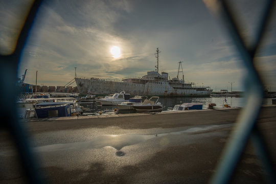 Side view of famous yugoslavian dictator Tito 's ship Galeb, moored in Rijeka, Croatia. Rusty decaying ship, just a shade of former glory in autumn sun.