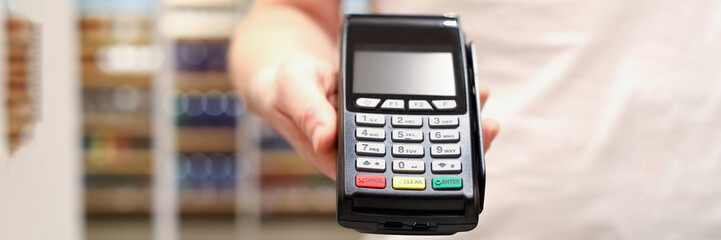 Male businessman hand hold POS terminal closeup. Fast digital payment concept