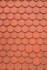 Red or orange roof tiles, looking directly from above. Good background of red roof tiles.