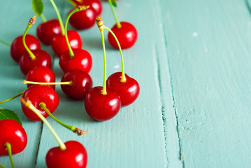sour cherry fruits on old blue wooden table background