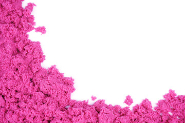 Kinetic sand of pink color on an isolated white background. Sand for children's creativity, leisure...
