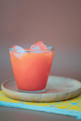 Glass of fresh carrot with ice.
