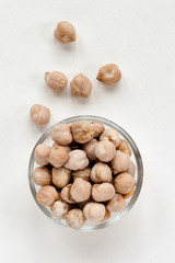 whole chickpeas in a plate on a white background