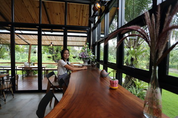 Fototapeta na wymiar Woman sitting in a cafe in Chon Buri, Thailand