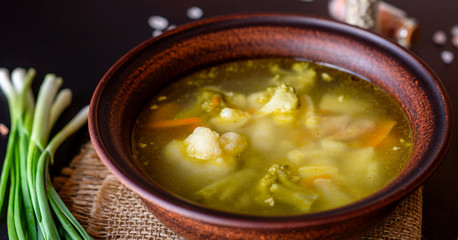 Fresh vegan soup with broccoli, cauliflower, asparagus and carrots