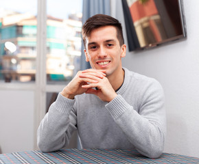 Portrait of successful young man in living room