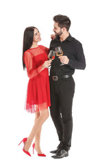 Happy couple with glasses of champagne on white background