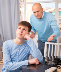 Man scolding son at home