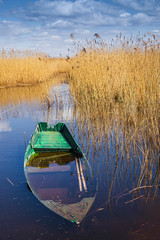 at the edge of the canal stands the boat in the water