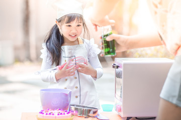 Close up background view Of cute young girls cooking desserts, with an oven and flour, cooking business concepts,learning models and marketing plans