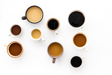 Many cups of coffee on white desk top view