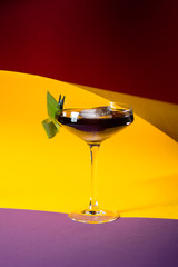 alcohol cocktail with garnish on the colorful background