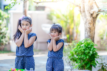 Close-up background view of cute Asian girls,who are experimenting with cooking or mixing food colors, concepts of learning to live life in a family,and studying new perspectives outside of the class