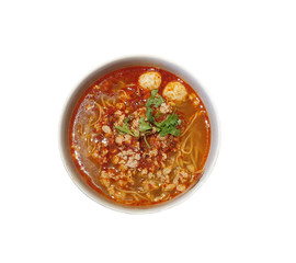 Top view of a bowl of spicy tom yum noodles soup topped with coriander.