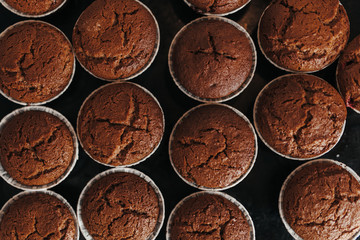 Chocolate muffins bakery. Brownie cupcakes on the baking pan. Baking at home, home bakery.