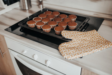 Chocolate muffins bakery. Brownie cupcakes on the baking pan. Baking at home, home bakery.