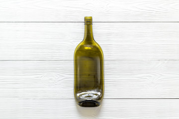 Fototapeta premium Wine bottle on white wooden background top view copy space
