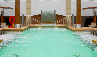Indoor Adult only area with whirlpools and thalasso swimmingpool under glass skylight roof with loungers for relaxation and wellness on Celebrity Cruises cruiseship or cruise ship liner