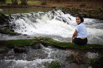 Woman and Nam Tum waterfall in Chanthaburi at thailand	