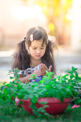 Close-up background view of a cute girl who is watering plants or growing vegetables for health, a crop cultivation program and business expansion.