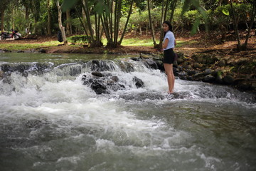 Woman and Nam Tum waterfall in Chanthaburi at thailand	