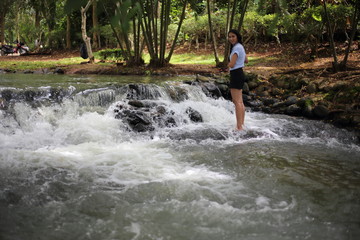 Woman and Nam Tum waterfall in Chanthaburi at thailand	