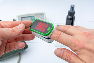Pulse Oximeter, finger digital device to measure person`s oxygen saturation. Reduced oxygenation is an emergency sign of pneumonia. Prevention and diagnosis of mers covid 19